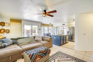 a living room with a couch and a ceiling fan at Private Pool and Grills North Phoenix Retreat! in Phoenix