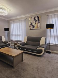 a living room with a couch and a table at Townhouse in Dundee
