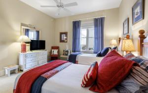 a bedroom with two beds and a flat screen tv at Another Day on 30A by Oversee 30A in Santa Rosa Beach