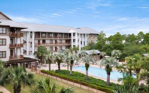 an aerial view of a resort with a pool and palm trees at Another Day on 30A by Oversee 30A in Santa Rosa Beach