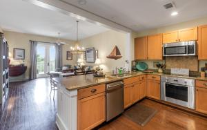 a kitchen with wooden cabinets and a counter top at Another Day on 30A by Oversee 30A in Santa Rosa Beach