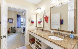 a bathroom with two sinks and a large mirror at Another Day on 30A by Oversee 30A in Santa Rosa Beach +19 photos
