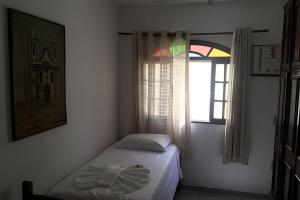 Ένα ή περισσότερα κρεβάτια σε δωμάτιο στο Casa de Praia - Vá a pé pra praia!