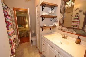 a bathroom with a sink and a toilet and a mirror at Blackbeard`s Hideaway in Key West +14 photos