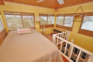 a bedroom with a bed in a room with windows at Blackbeard`s Hideaway in Key West