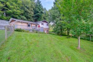 a house with a fence and a yard with a tree at Fire Pit and Mountain Views Quiet Sparta Getaway in Sparta