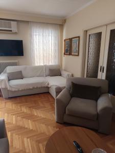 a living room with a couch and a couch and a table at ΕΥΕΛΗ in Edessa +35 photos