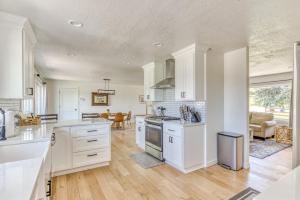 a large kitchen with white cabinets and a table at Vogel Vacation - Spacious Secluded, Hot Tub & Game Room in Damascus