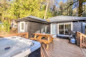 a wooden deck with a table and a tub at Riverbend Cabin 1 - Lolo Bungalow in Rhododendron