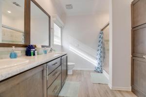 a bathroom with a sink and a toilet and a mirror at Paradise Found in Key West +10 photos