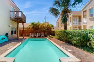 a swimming pool in the backyard of a house at Garden Breeze Condominiums #3 in South Padre Island