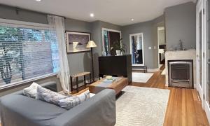 a living room with a couch and a fireplace at Airport-YVR GuestHouse in Richmond