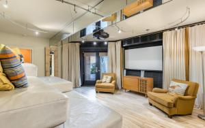 a living room with a couch and a flat screen tv at Atypical by Oversee 30A in Santa Rosa Beach +35 photos