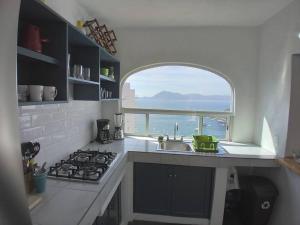 a kitchen with a sink and an arch window at Manzanillo Breath Taking Views in Manzanillo