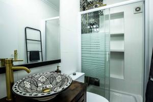 a bathroom with a sink and a glass shower at Sea View La Mata Apartment in La Mata +19 photos