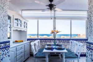 a kitchen with a table with chairs and a window at Sea View La Mata Apartment in La Mata