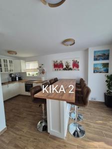 a kitchen with a wooden table in a room at Kika apartmani-FREE PARKING- 7 km od centra in Zagreb