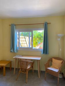 a room with a table and chairs and a window at Bungalow Heike 2 (Only Adults) in Valle Gran Rey +2 photos