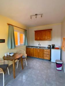 a kitchen with a wooden table and a table and chairs at Bungalow Heike 2 (Only Adults) in Valle Gran Rey