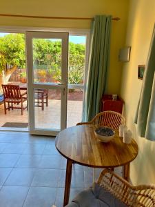 a room with a table and chairs and a patio at Bungalow Heike 2 (Only Adults) in Valle Gran Rey