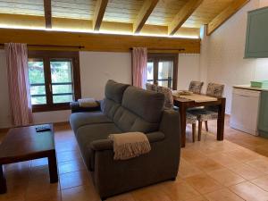 a living room with a couch and a table at Zara Villanúa in Villanúa