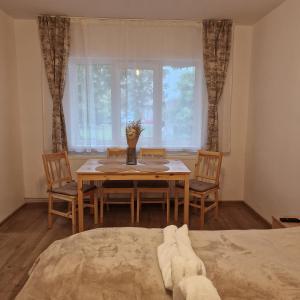 a dining room with a table and chairs and a window at Harmony Residence in Sfântu-Gheorghe