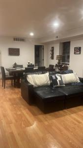 a living room with a black couch and a table at Comfort Apartment Near Newark Airport in Newark