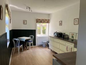 a kitchen with a table and a table and chairs at „Altes Forsthaus“ am Schloss in Uelzen