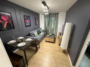 a living room with a couch and a table at 50 nuances de rouge in Guebwiller