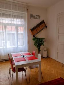 a dining room with a table and chairs and a plant at Treestyle Deluxe Rooms in Budapest +32 photos