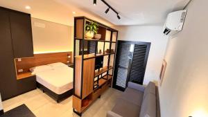 a bedroom with a bed and a book shelf at Voá Flat in Capivari