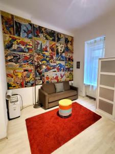 a living room with a couch and a red rug at Treestyle Deluxe Rooms in Budapest