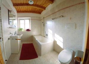 a bathroom with a tub and a toilet and a sink at Villa Andre in Tires