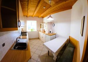 a small kitchen with a bench and a sink at Villa Andre in Tires +16 photos