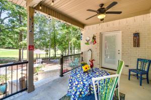 a porch with a table and chairs and a ceiling fan at Golf Course View Hot Springs Village Home! in Hot Springs Village