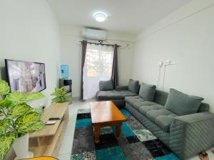 a living room with a couch and a table at Bahari Three Bedroom Mombasa in Mombasa