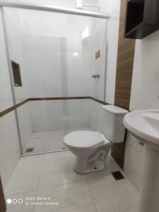 a bathroom with a shower and a toilet and a sink at Hotel Prime in Hortolândia