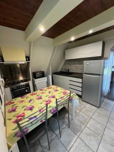 a kitchen with a table with flowers on it at La casina di Ginevra in Marina di Massa +1 photo