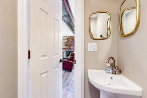 a bathroom with a sink and two mirrors at Mountain Lea Hideaway in Sapphire +17 photos