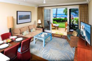 a living room with a couch and a table at Villa 102 at Turtle Bay in Kahuku