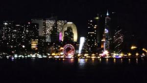 a city skyline at night with a ferris wheel at Green Cape Tower in Batumi