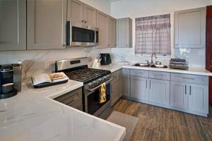a kitchen with white cabinets and a stove top oven at Scotland Villa 1 in Nazareth