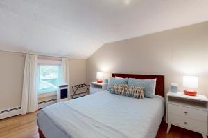 a bedroom with a large bed and a window at Seaglass Serenade in Old Orchard Beach