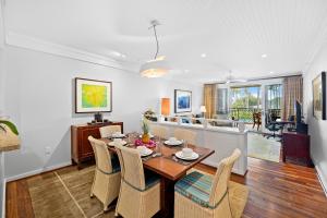 Un comedor y una sala de estar con mesa y sillas. en 3-Bed Villa 208 at Turtle Bay, en Kahuku