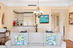 a living room with a white couch and a table at 3-Bed Villa 313 at Turtle Bay in Kahuku