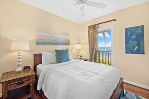 a bedroom with a bed with a view of the ocean at 3-Bed Villa 313 at Turtle Bay in Kahuku +45 photos