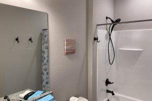 a bathroom with a mirror and a shower stall at Sunset Revival in St. George Island +27 photos
