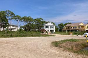 a house sitting on the side of a dirt road at Sunset Revival in St. George Island