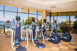 a gym with treadmills and elliptical machines at Villa 305 at Turtle Bay in Kahuku