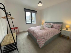 a bedroom with a bed and a window at Coastal Links, Main Street Portrush, 1 to 5 guests in Portrush
